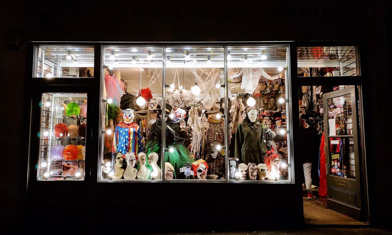 A storefront with costumes and mannequins in the window